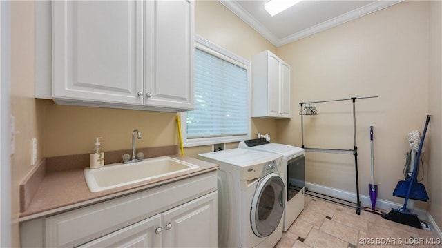 washroom featuring sink, light tile patterned floors, cabinets, ornamental molding, and washing machine and clothes dryer