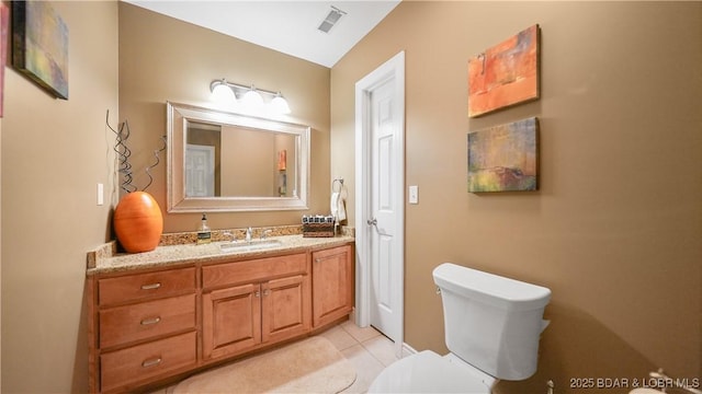 bathroom featuring tile patterned floors, toilet, and vanity