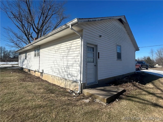 view of side of home featuring a yard