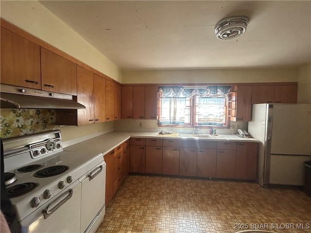 kitchen featuring sink and white appliances