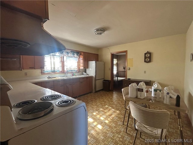 kitchen with sink, white appliances, and island range hood