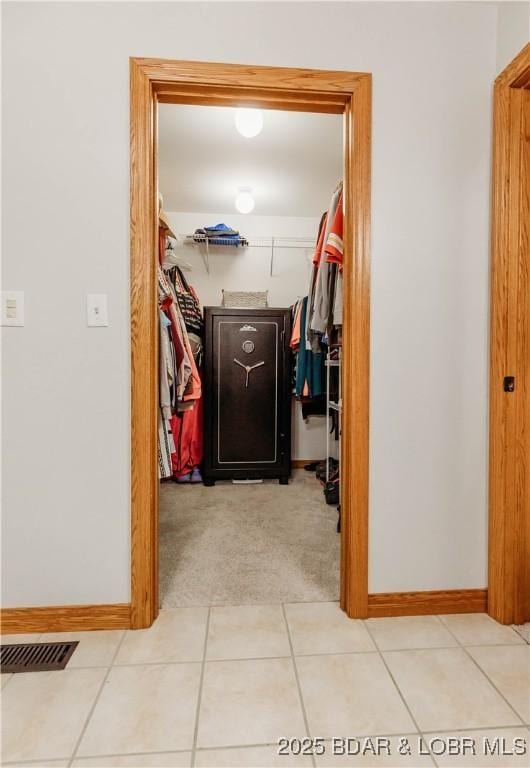 hall featuring light tile patterned floors