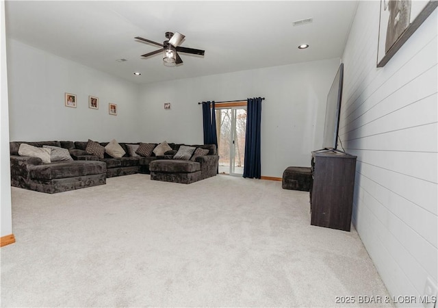 carpeted living room with ceiling fan