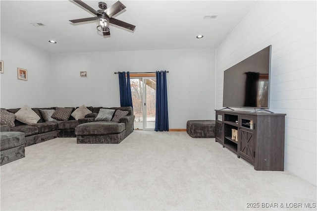 living room featuring light carpet and ceiling fan