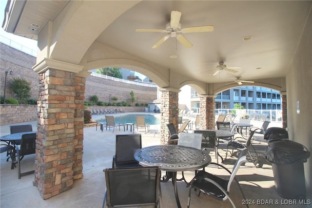 view of patio featuring a fenced in pool and ceiling fan