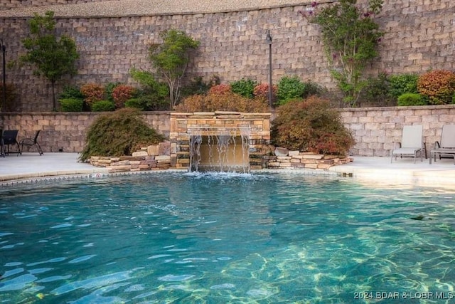 view of pool with pool water feature