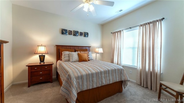 bedroom featuring light carpet and ceiling fan