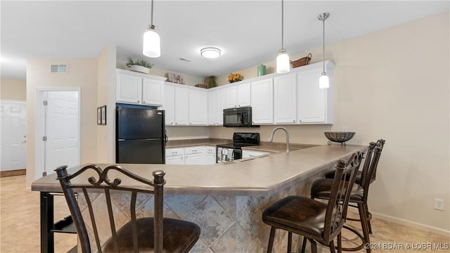 kitchen with a breakfast bar, decorative light fixtures, white cabinetry, sink, and black appliances