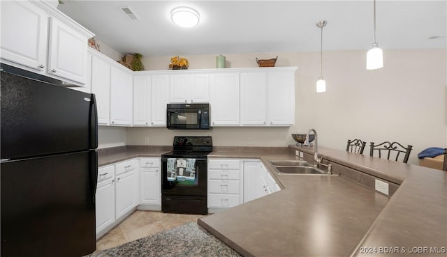 kitchen with sink, pendant lighting, white cabinets, and black appliances