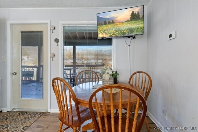 dining space with hardwood / wood-style floors