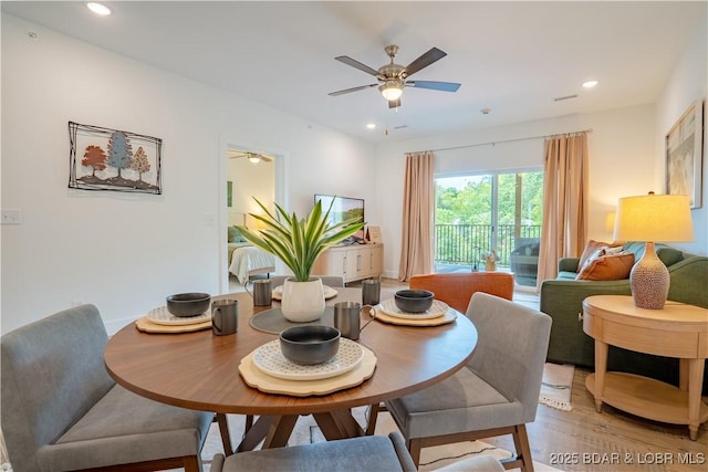 dining area with ceiling fan and light hardwood / wood-style flooring