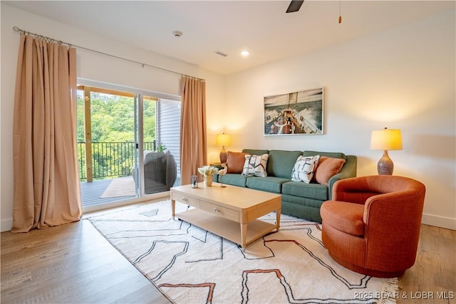 living room with ceiling fan and light hardwood / wood-style floors