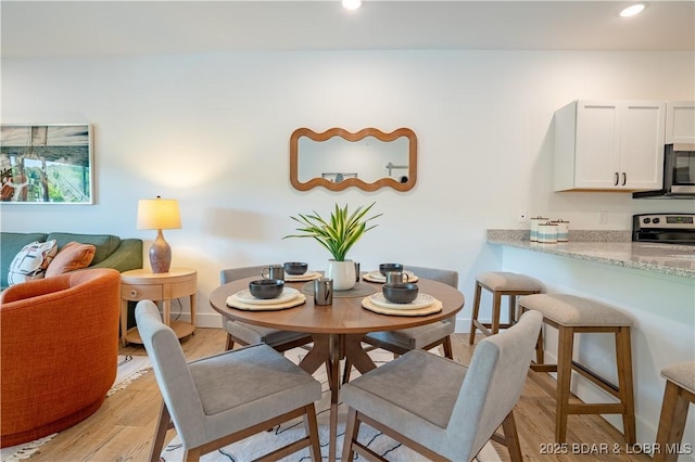 dining room with light wood-type flooring