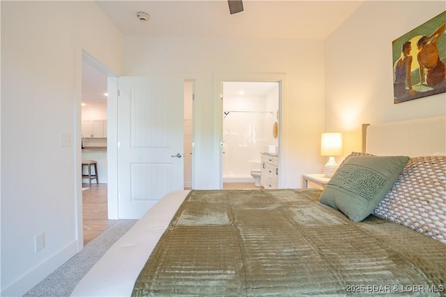 bedroom with light colored carpet and ensuite bathroom