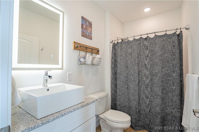 bathroom with vanity, a shower with curtain, and toilet