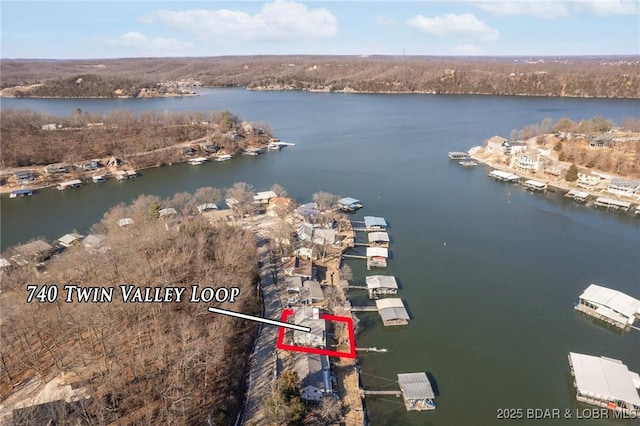 birds eye view of property with a water view