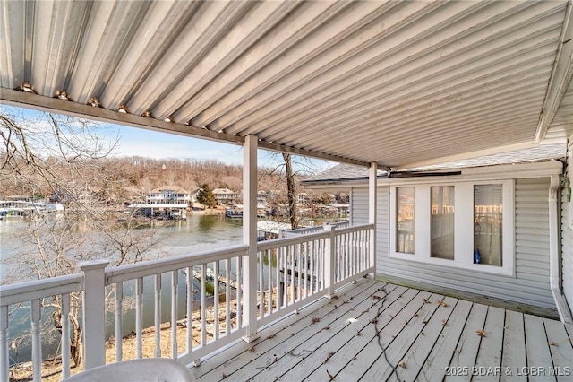 wooden terrace featuring a water view