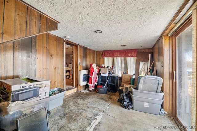 miscellaneous room featuring wooden walls and a textured ceiling