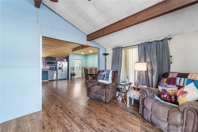 living room featuring vaulted ceiling with beams and hardwood / wood-style floors