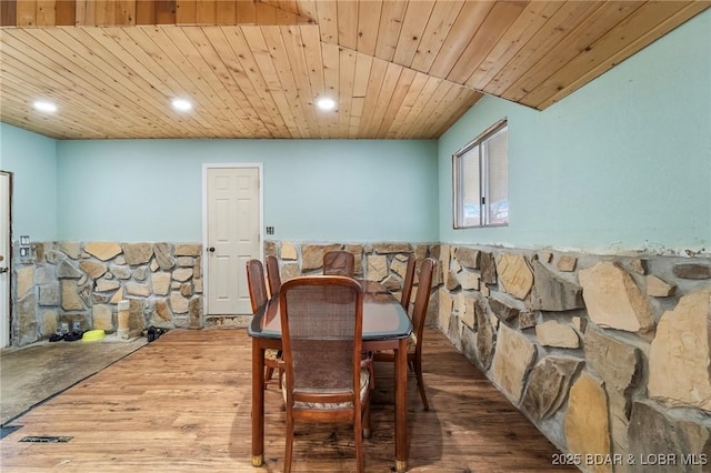 dining space with wood ceiling and hardwood / wood-style flooring