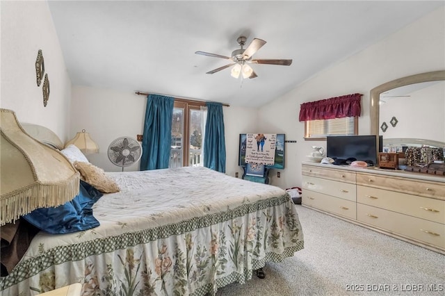 carpeted bedroom featuring multiple windows, vaulted ceiling, and ceiling fan