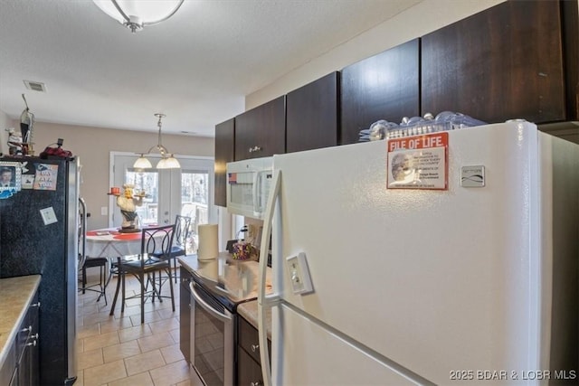 kitchen featuring pendant lighting, stainless steel appliances, dark brown cabinets, and light tile patterned floors