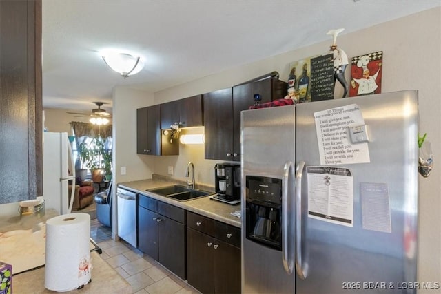 kitchen featuring light tile patterned flooring, dark brown cabinetry, sink, appliances with stainless steel finishes, and ceiling fan