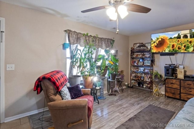 interior space featuring wood-type flooring and ceiling fan