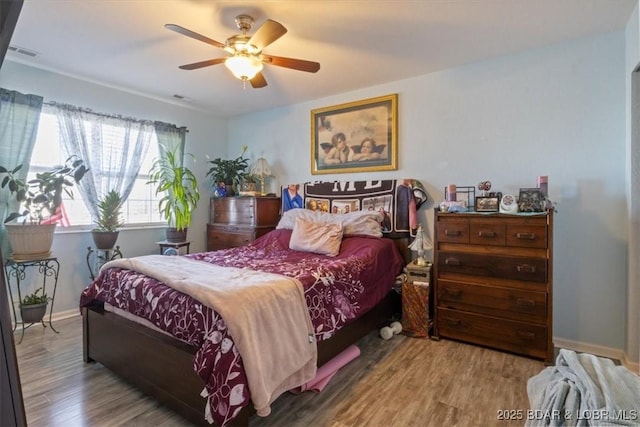 bedroom featuring hardwood / wood-style flooring and ceiling fan