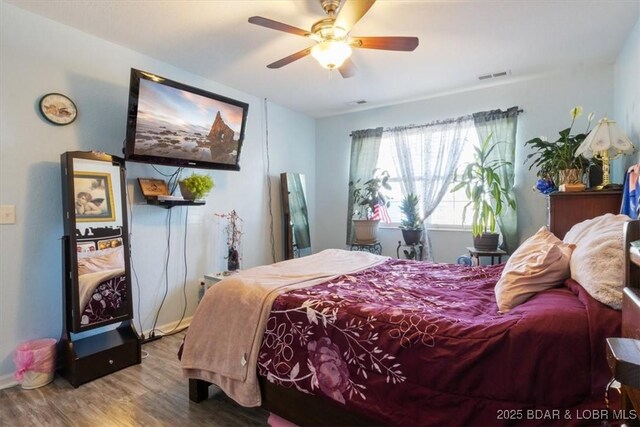 bedroom with ceiling fan and wood-type flooring