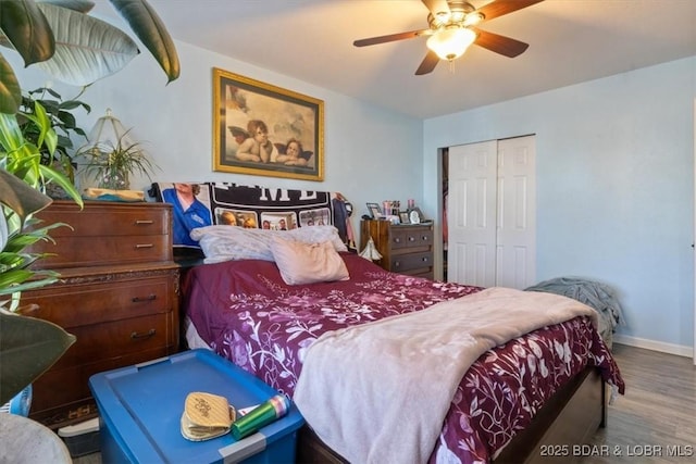 bedroom with hardwood / wood-style flooring, a closet, and ceiling fan