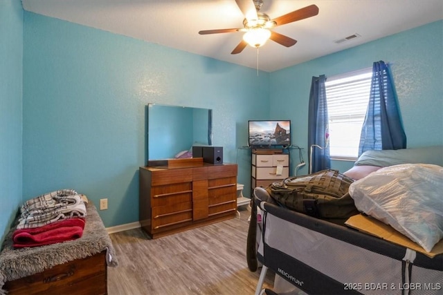 bedroom featuring hardwood / wood-style flooring and ceiling fan