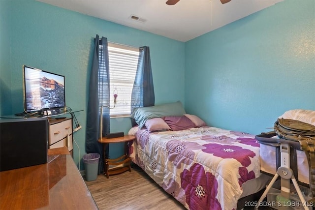 bedroom featuring ceiling fan and light wood-type flooring