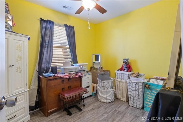 misc room with ceiling fan and light wood-type flooring