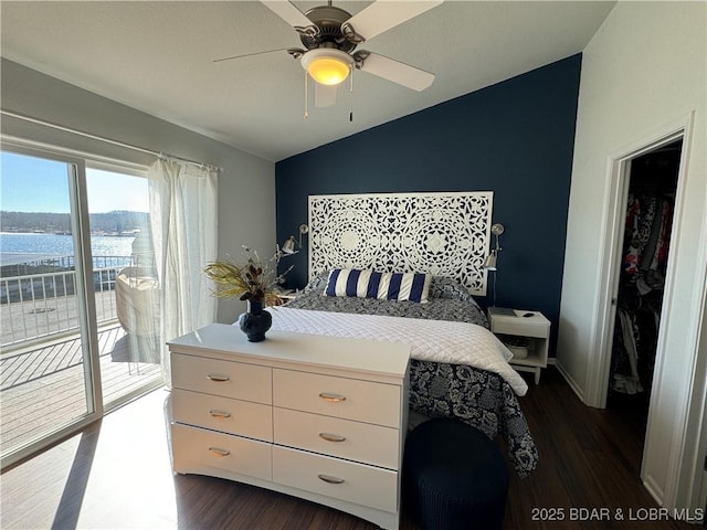 bedroom with vaulted ceiling, a water view, access to outside, and dark hardwood / wood-style flooring