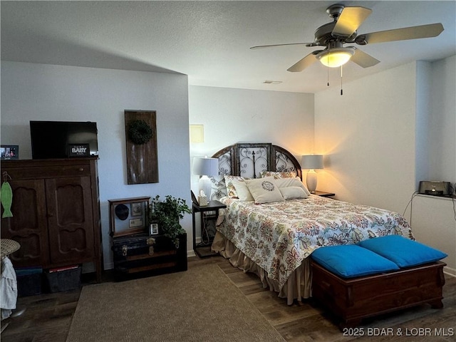 bedroom with dark wood-type flooring and ceiling fan