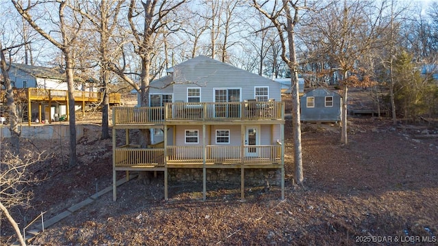 rear view of property featuring a wooden deck