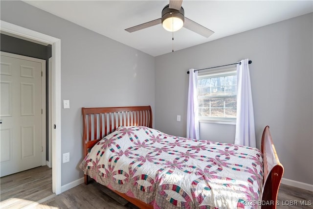 bedroom with ceiling fan and wood-type flooring