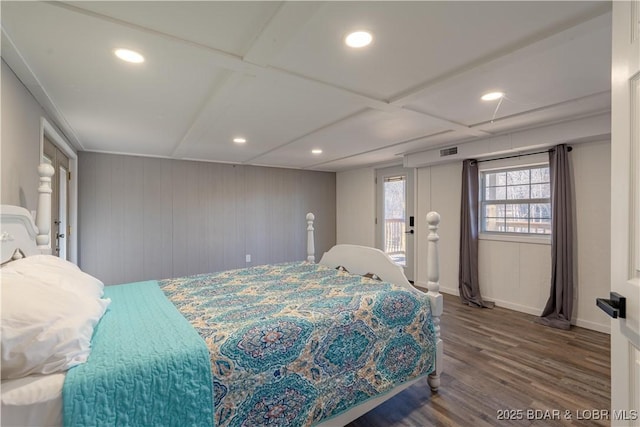 bedroom featuring wood-type flooring, coffered ceiling, and access to exterior