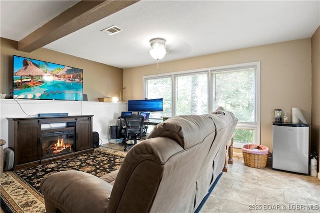 living room featuring beamed ceiling