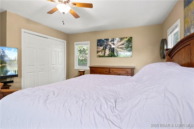 bedroom with ceiling fan and a closet