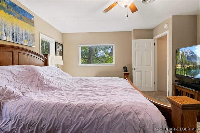 carpeted bedroom with ceiling fan