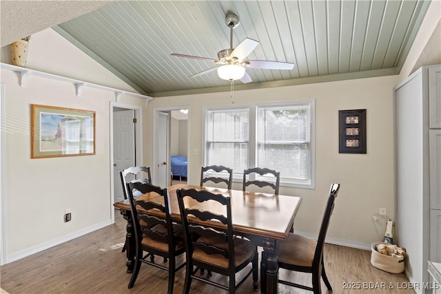 dining area with hardwood / wood-style flooring, ceiling fan, vaulted ceiling, and wooden ceiling