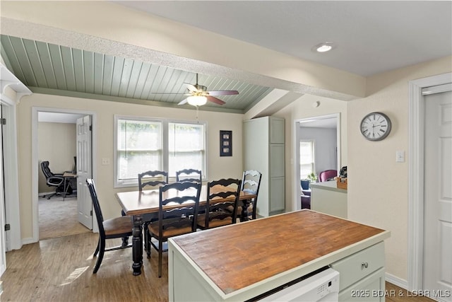 dining room with ceiling fan, wood ceiling, and light hardwood / wood-style flooring