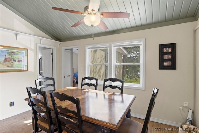 dining room featuring vaulted ceiling, hardwood / wood-style floors, and wood ceiling