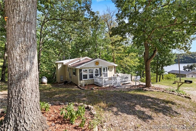 view of front of house featuring a deck with water view