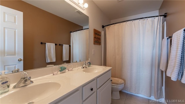 bathroom with vanity, tile patterned floors, and toilet