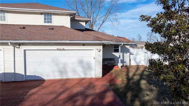 view of side of home featuring a garage