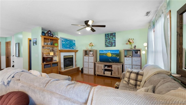 living room with ceiling fan and dark hardwood / wood-style floors