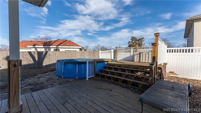 wooden deck with a covered pool